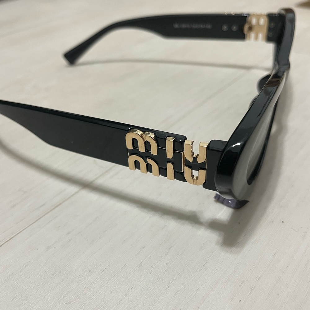 Mui Mui Black Sunglasses with Gold Logo Accent